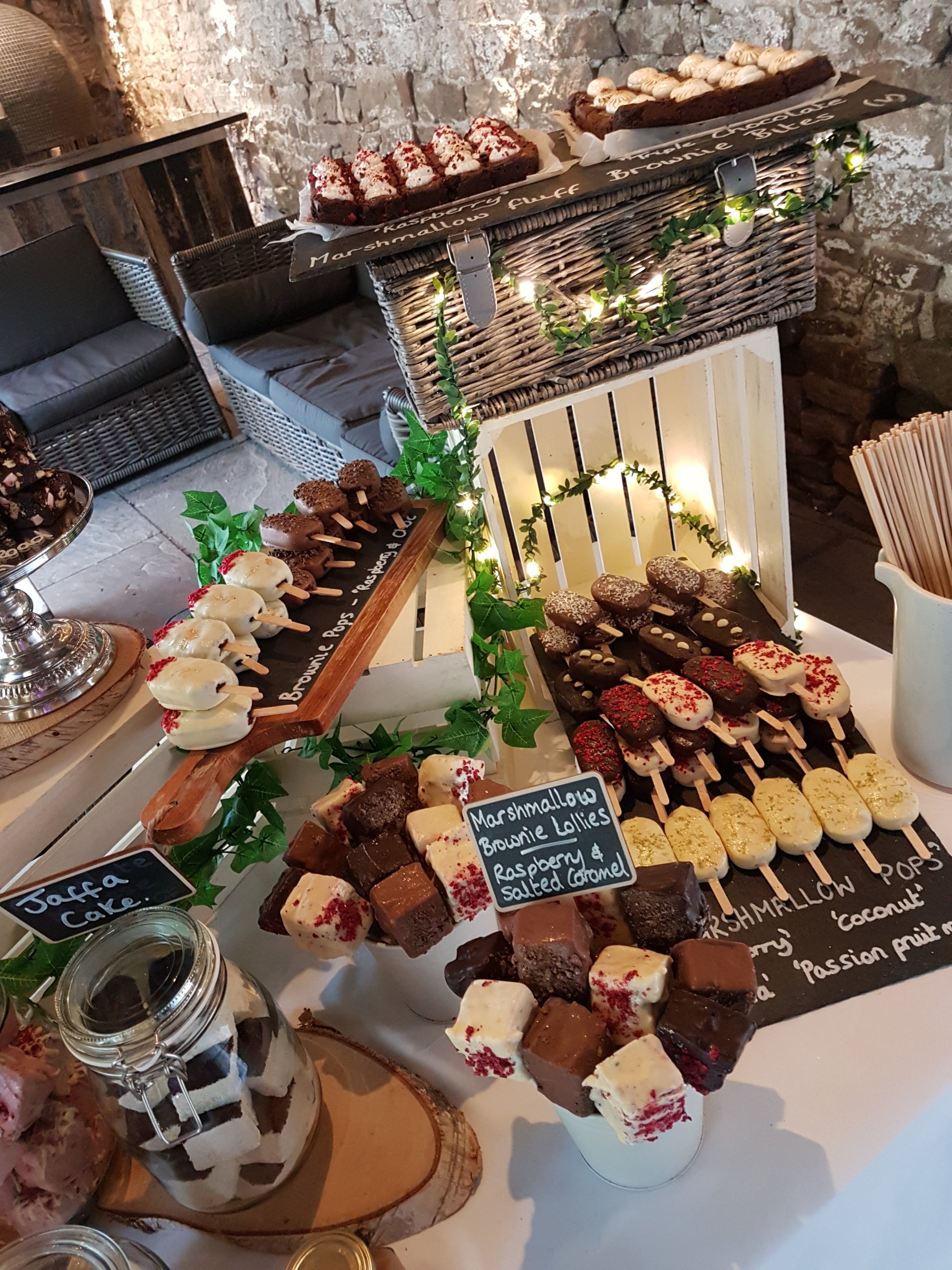 Display of various marshmallows and treats on a table with decorative elements at healey barn wedding venue smores and dessert table