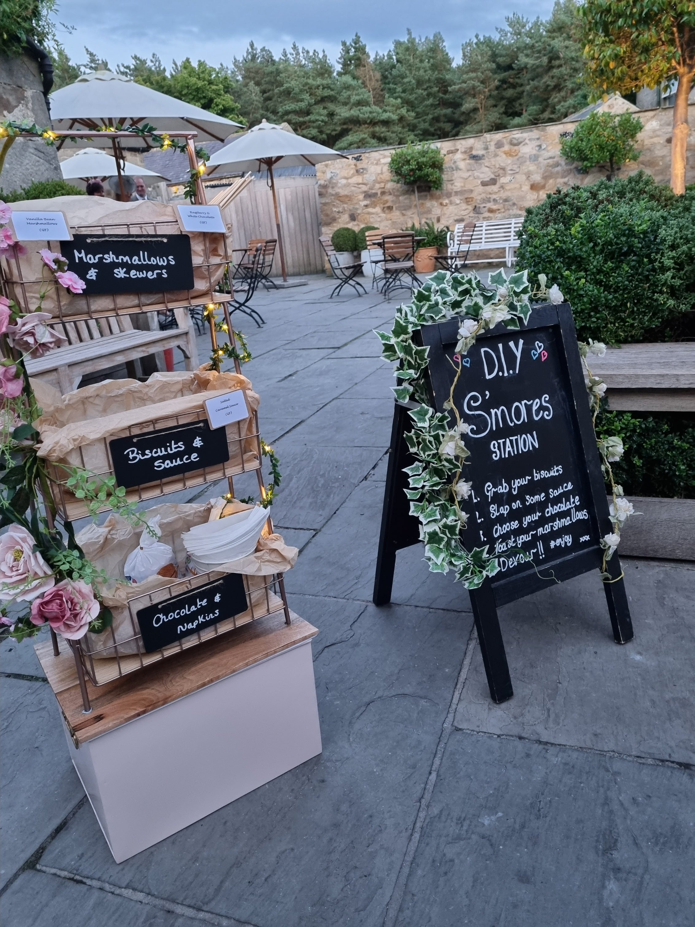 Outdoor setting with a mini DIY S'mores station and decorative elements at healey barn wedding venue