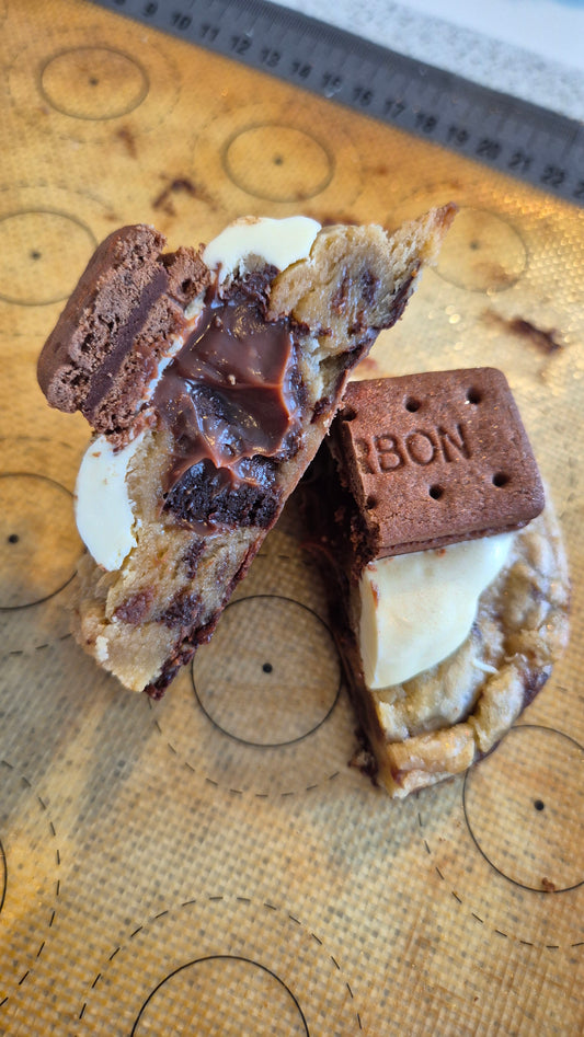 Chocolate cookie with cream filling on a wooden board