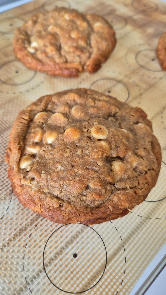 White chocolate chip filled cookie on a flat surface.